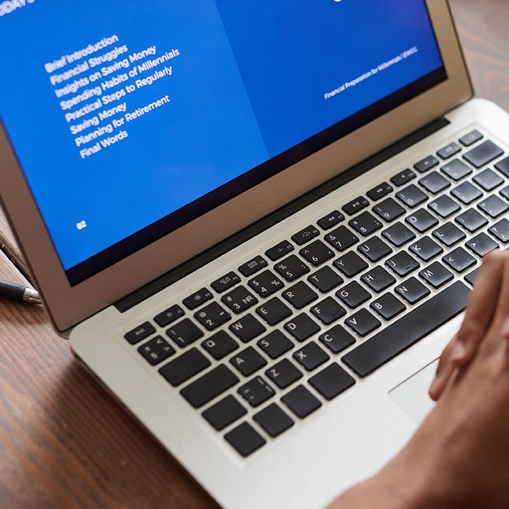 A person is using the laptop on the table