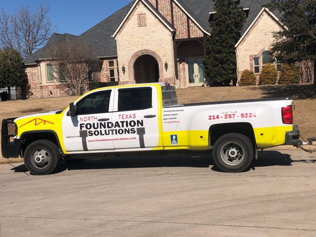 A truck parked in front of a house.