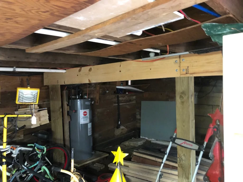 A room with wood floors and wooden beams.