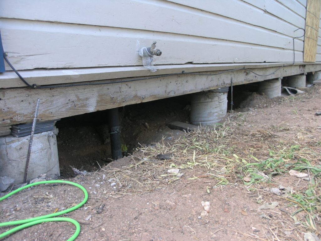 A green hose is connected to the ground.