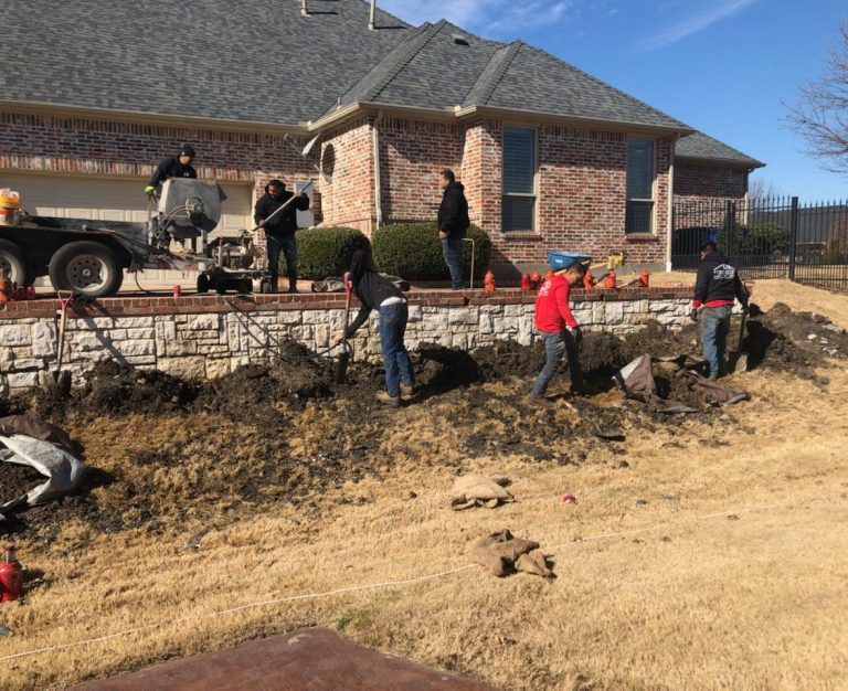 A group of people working on the side of a house.