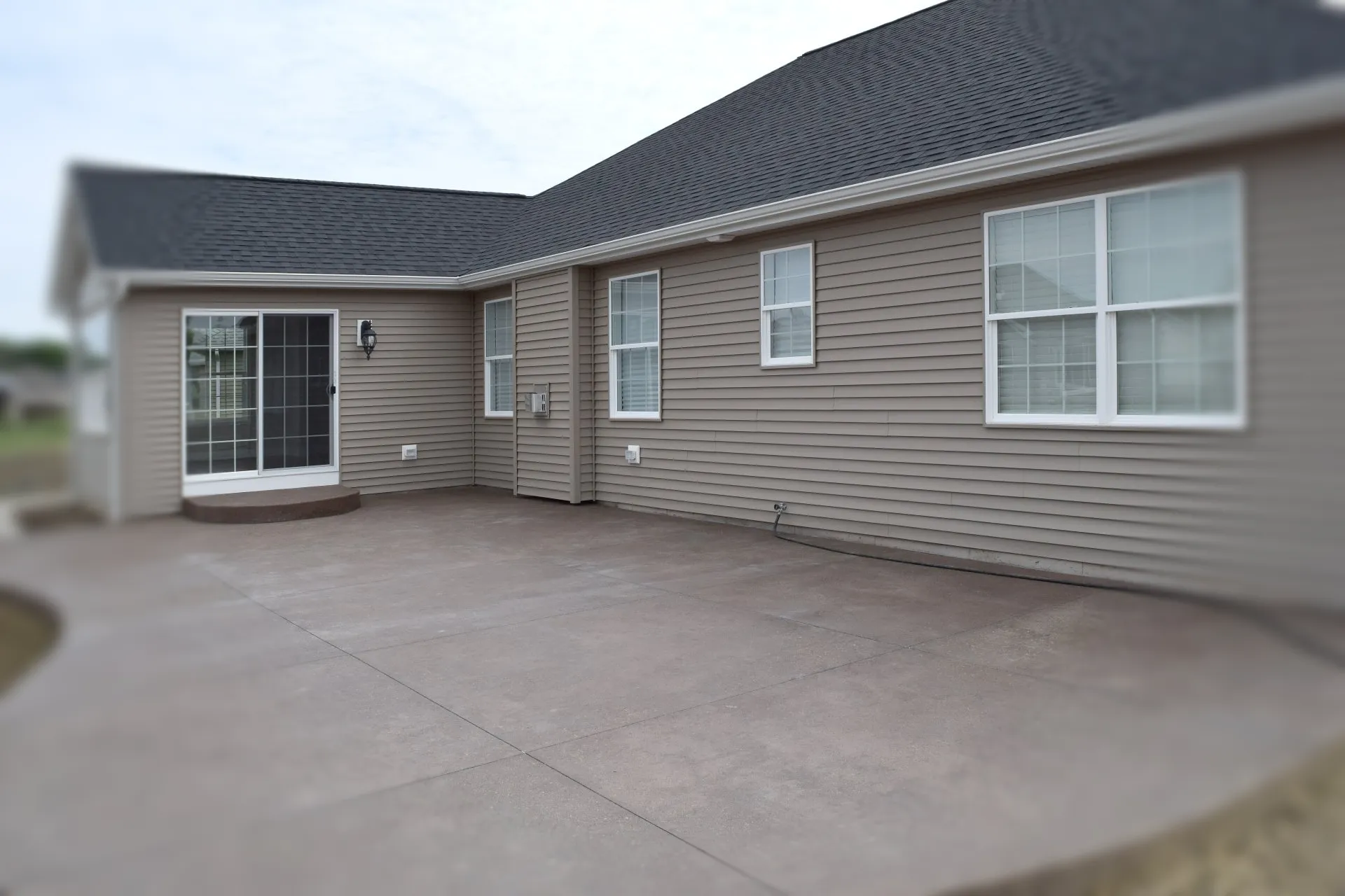 A large patio with windows and doors in the back.